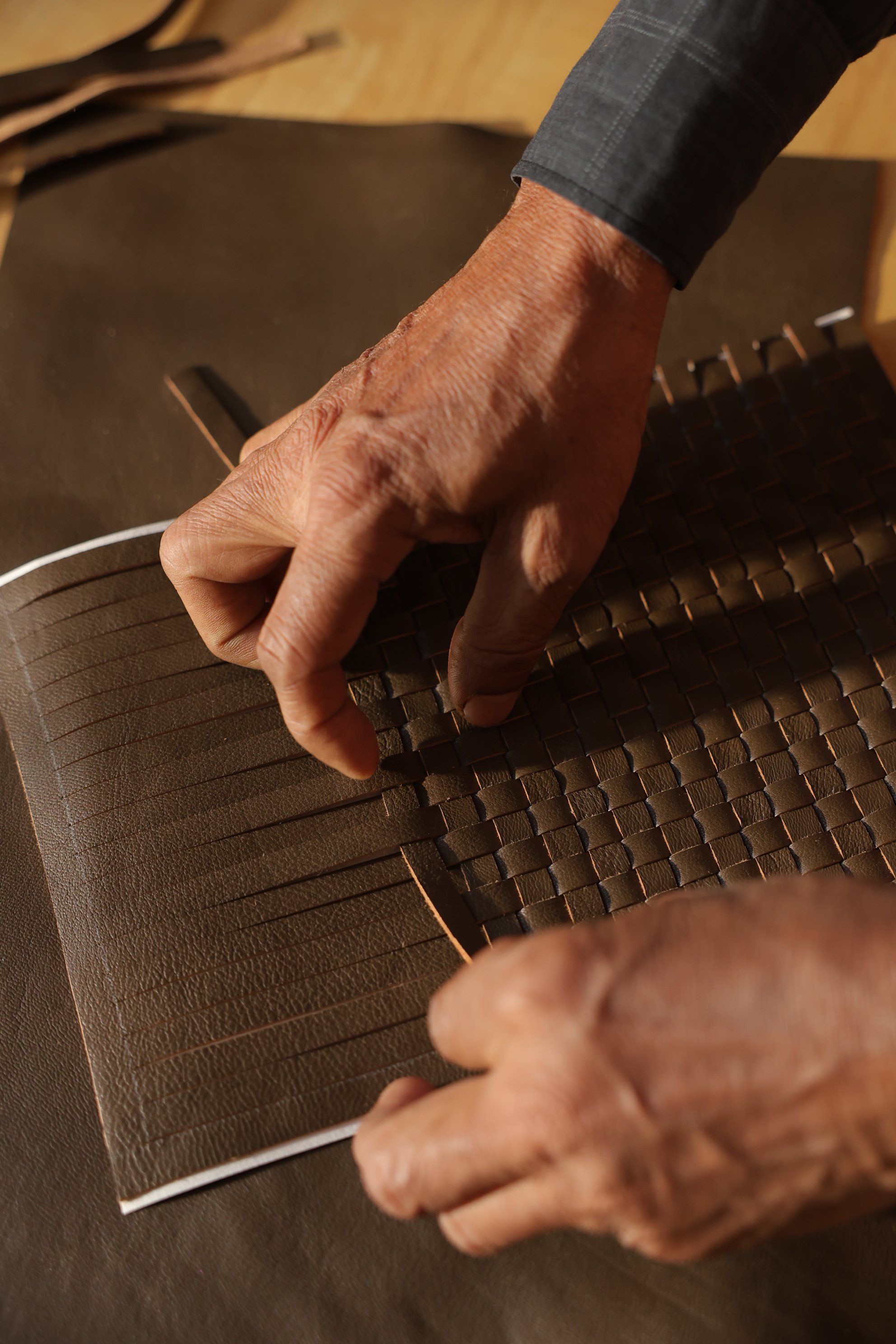 Artisan hand-weaving premium leather strips